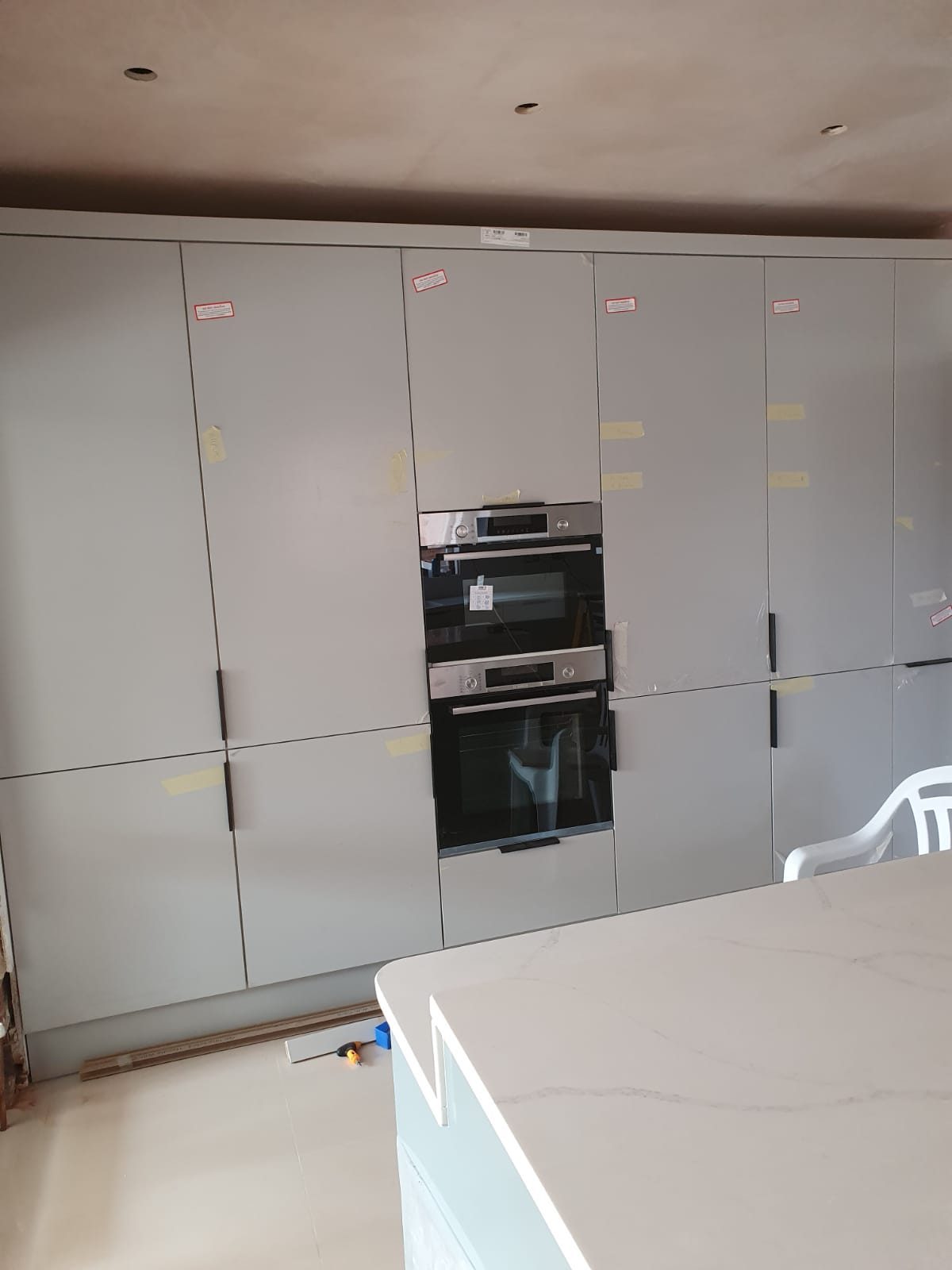 Tall kitchen unit run with built-in ovens, Thomas Joinery Services project work near Market Square, Ampthill MK45