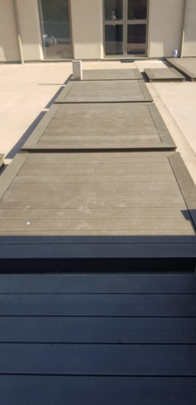 Composite deck laid with a step down to the garden, Thomas Joinery Services project work near Bromham Bridge, Bromham MK43