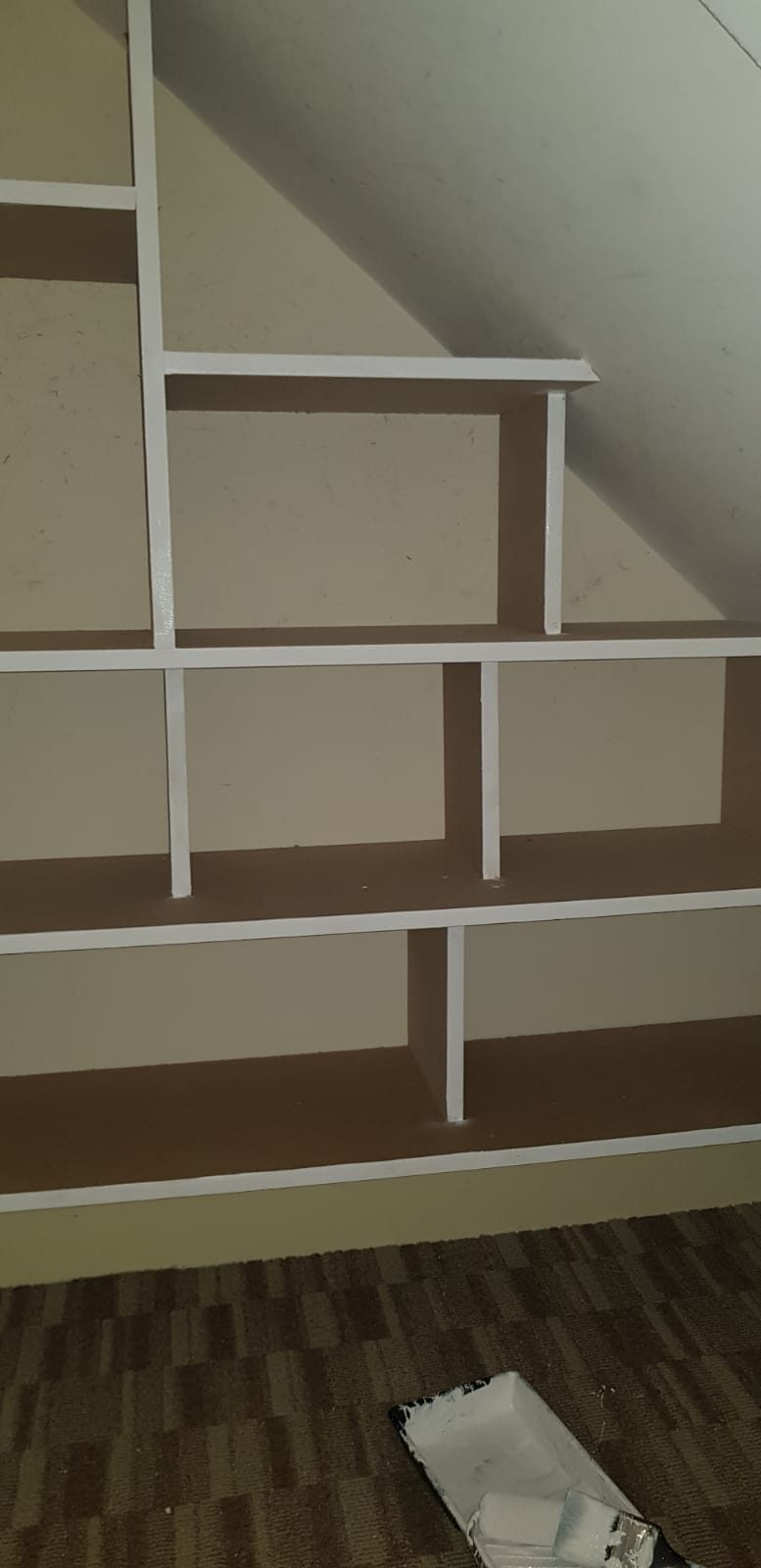 Bespoke under-stairs shelving built into the stair void