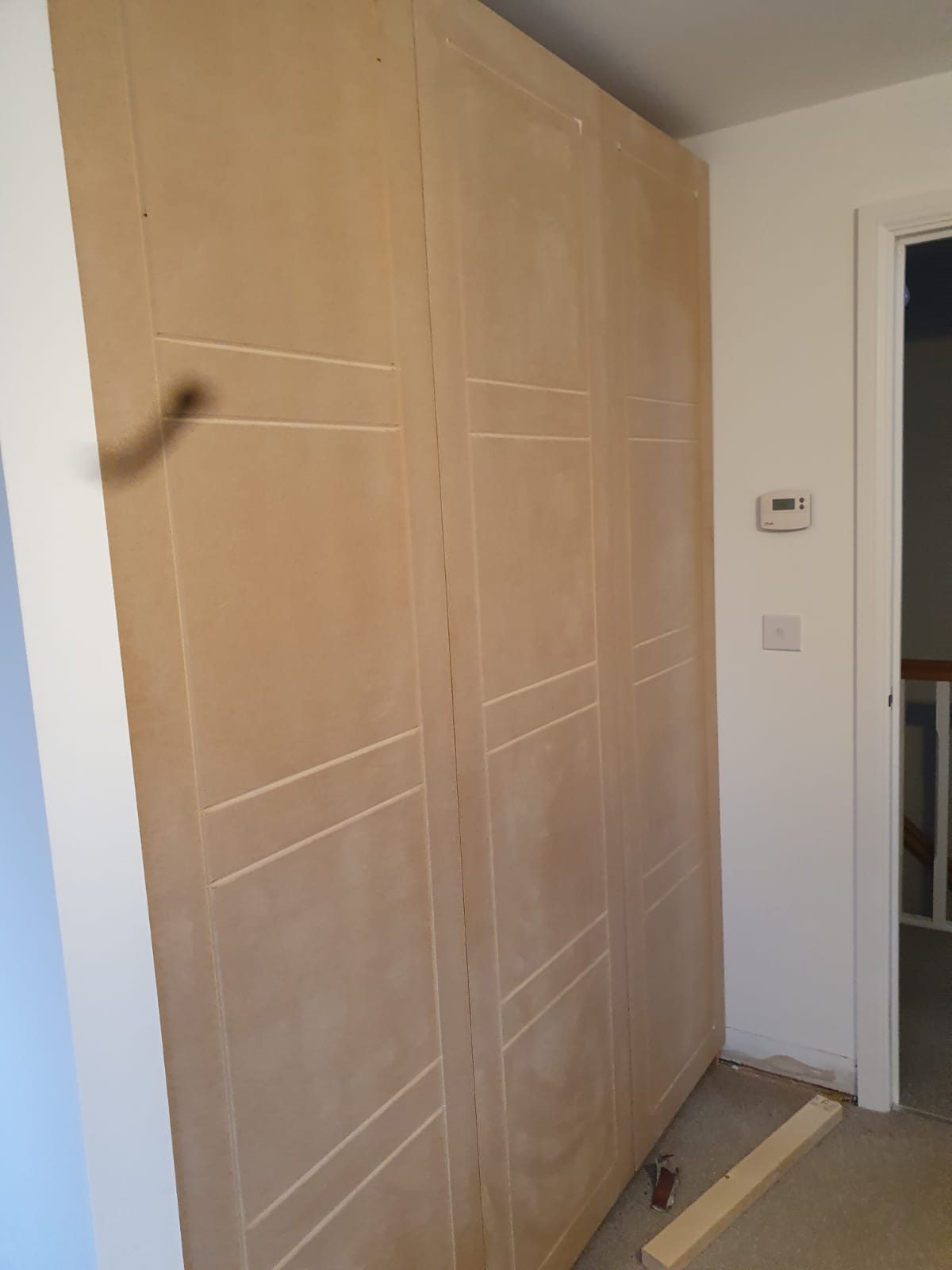 Oak fitted wardrobe run taken into the corner, Thomas Joinery Services project work near St Thomas of Canterbury Church, Clapham MK41