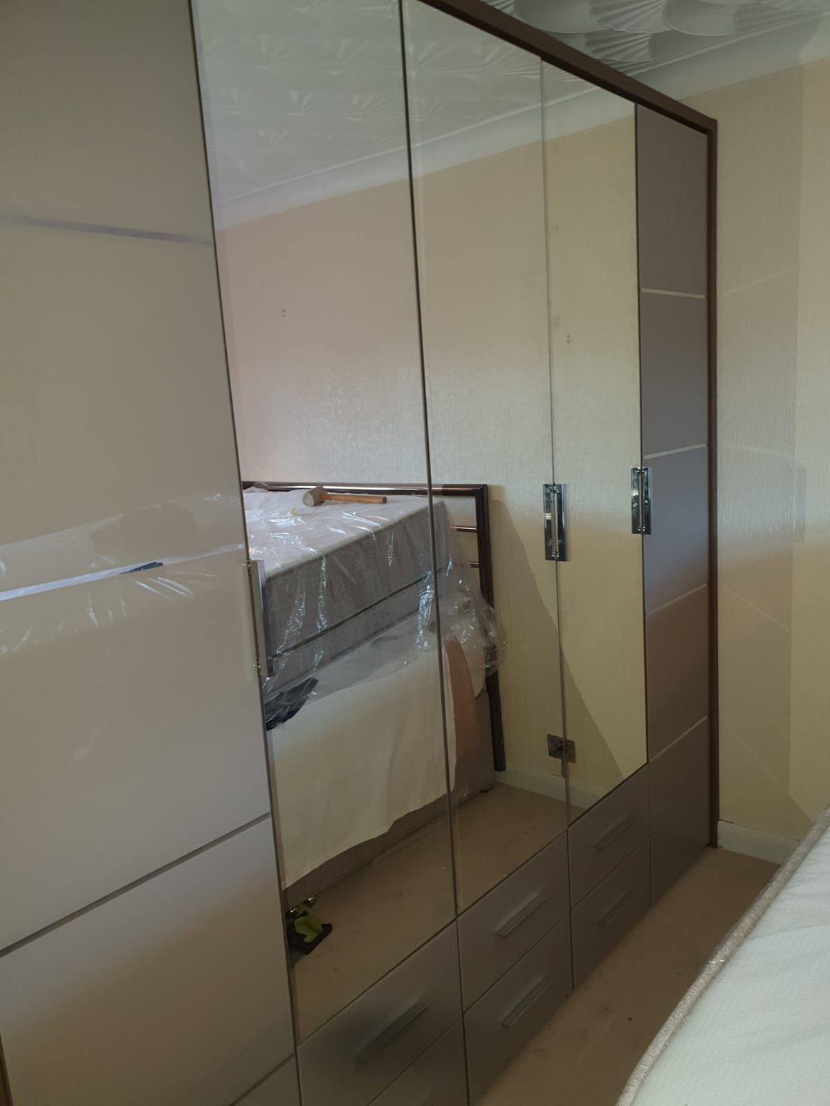 Mirror sliding doors across a bedroom wall, Thomas Joinery Services, Bedford